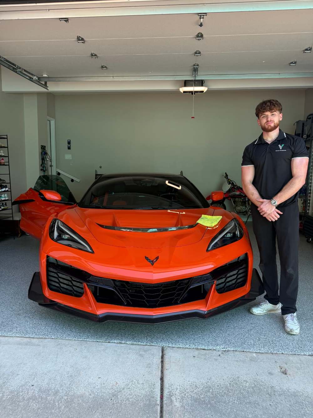 Vision Detailing specialist beside a freshly detailed Corvette Z06